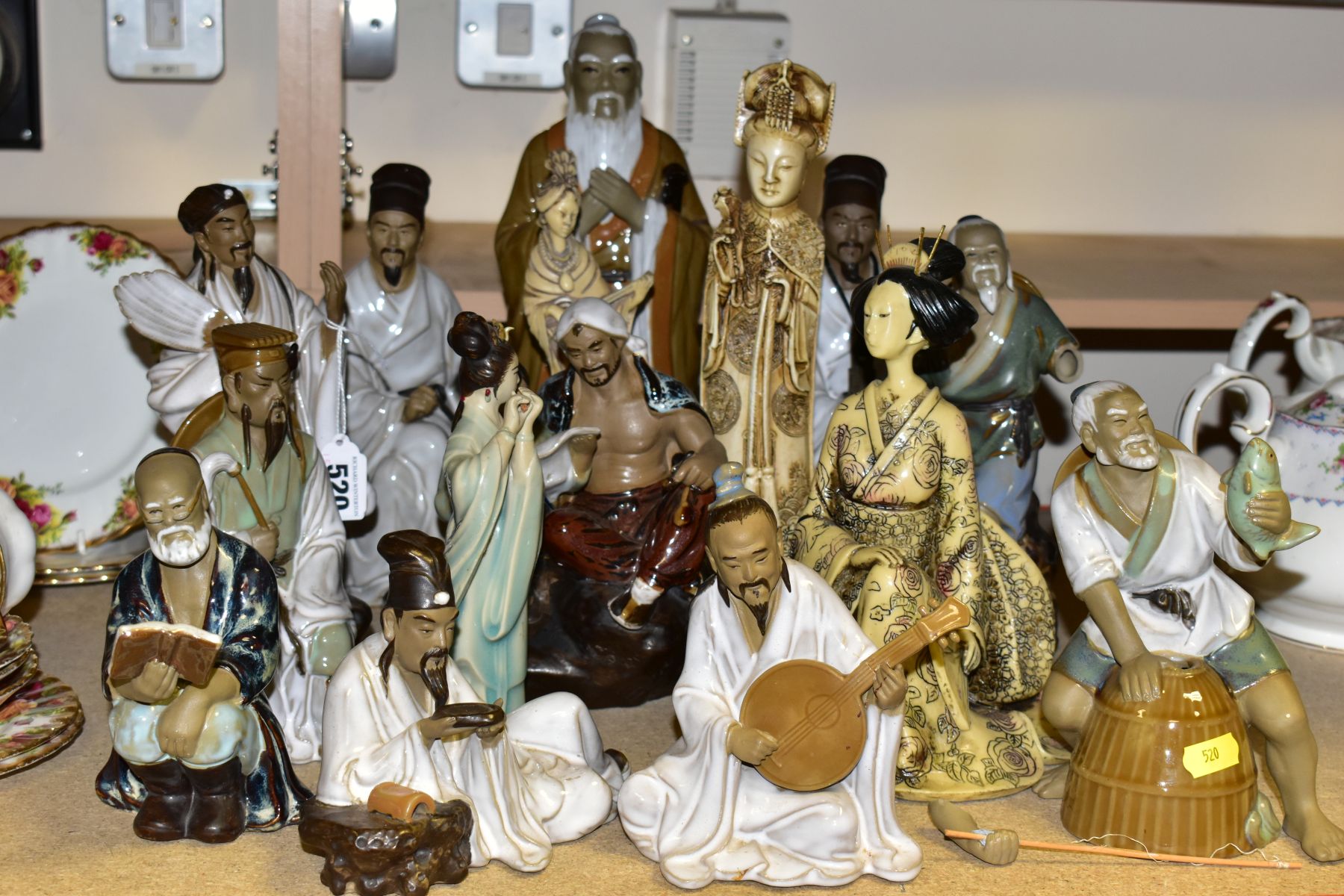 A GROUP OF MODERN ORIENTAL FIGURINES, to include fifteen figurines featuring people reading, fishing