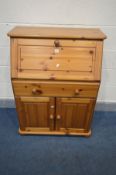 A PINE BUREAU, with a fall front door, above a long drawer and double cupboard doors, width 76cm x