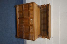 AN ARTS AND CRAFTS STYLE OAK SIDEBOARD, decorated with raised square panels, the raised back