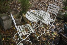 A DISTRESSED CIRCULAR WHITE PAINTED WOODEN SLATTED FOLDING TABLE, diameter 70cm x height 75cm with