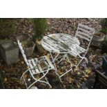 A DISTRESSED CIRCULAR WHITE PAINTED WOODEN SLATTED FOLDING TABLE, diameter 70cm x height 75cm with