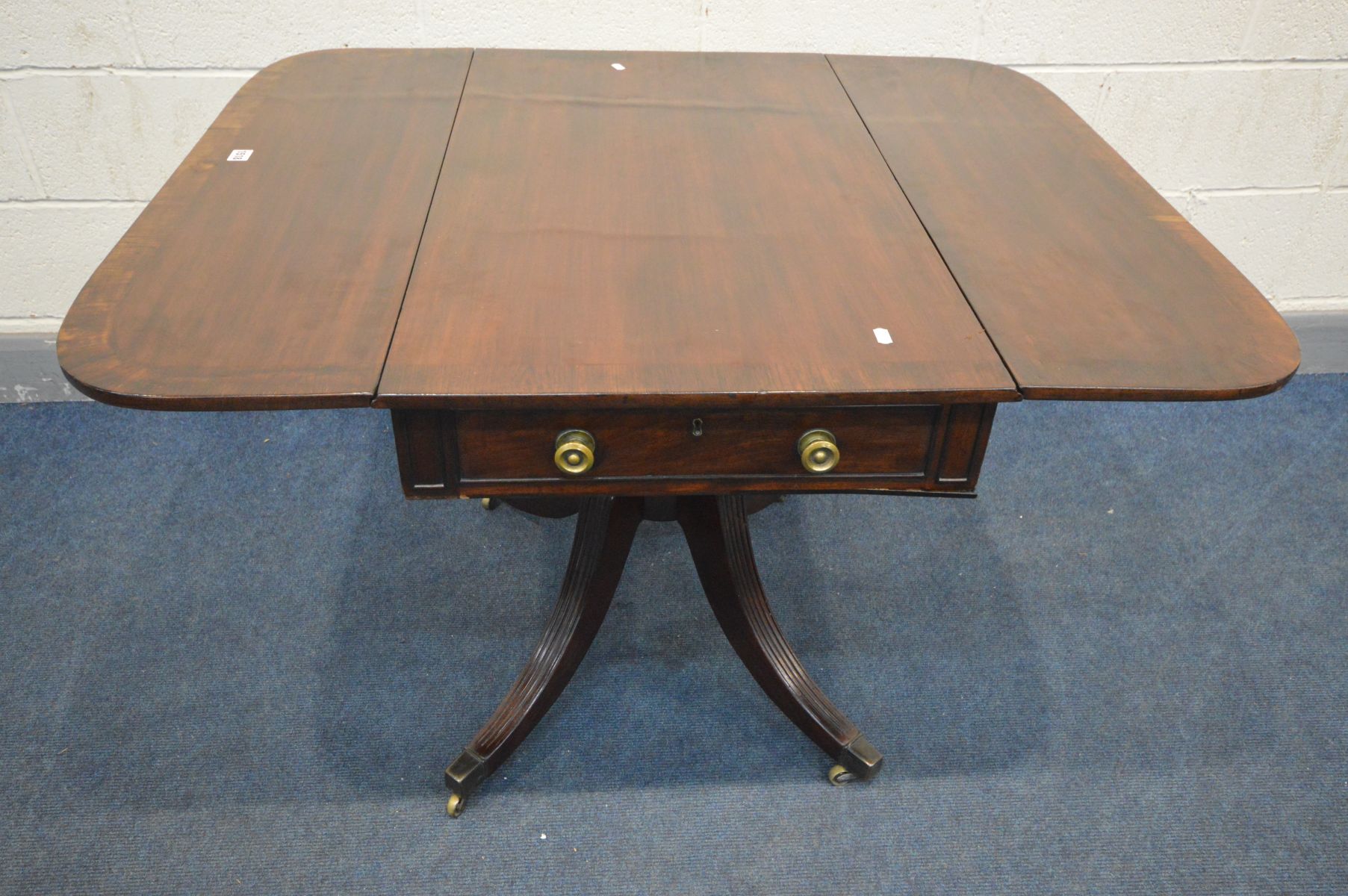 A REGENCY MAHOGANY AND ROSEWOOD CROSSBANDED DROP LEAF PEDESTAL PEMBROKE TABLE, a single drawer to