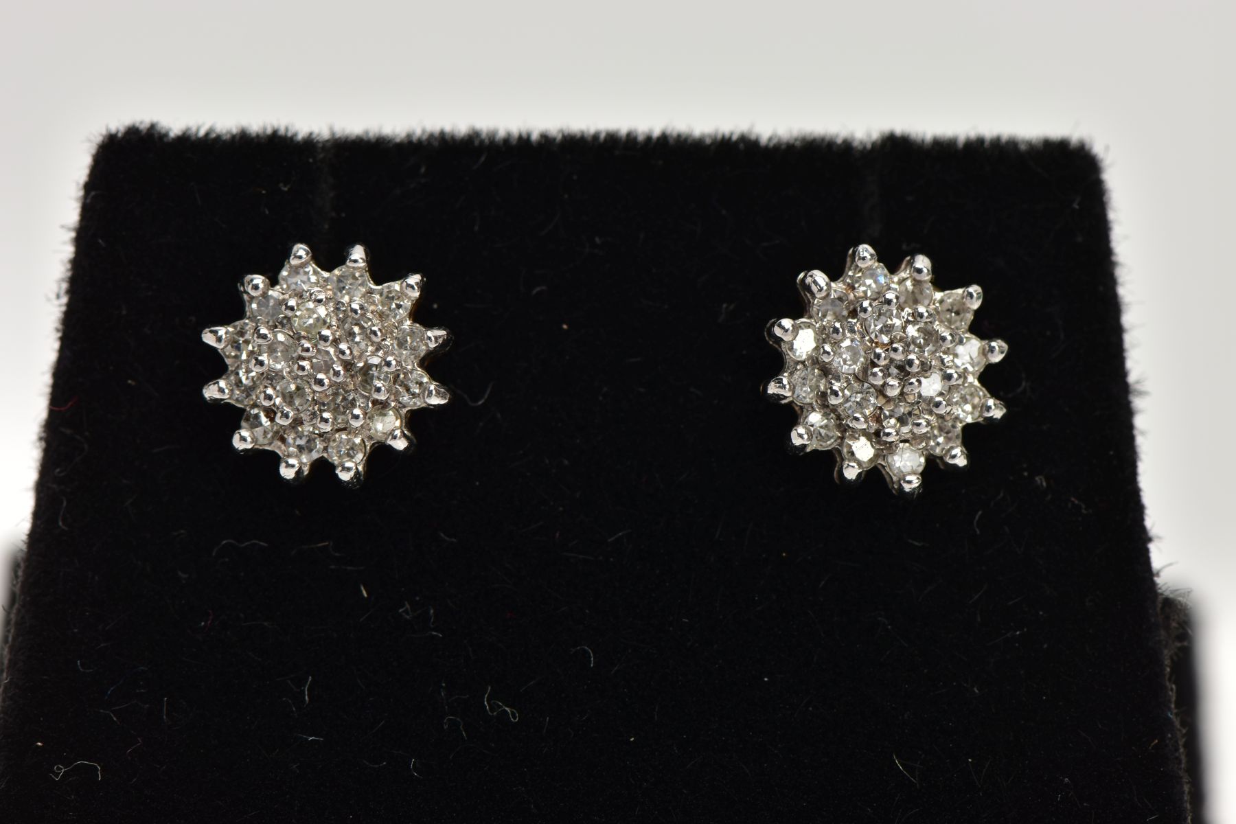 A PAIR OF 9CT GOLD DIAMOND CLUSTER EARRINGS, slightly raised cluster set with round brilliant cut