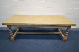 A LARGE LIGHT OAK REFECTORY TABLE, on barley twist supports, united by a H stretcher, length 211cm x