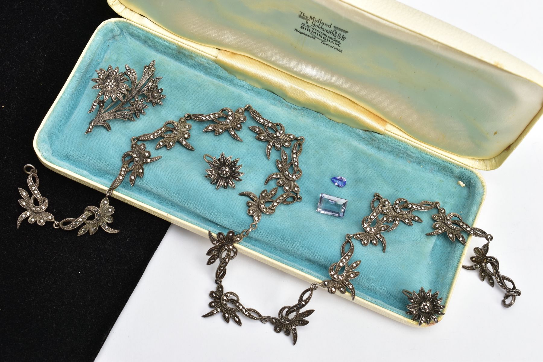 A WHITE METAL MARCASITE NECKLACE, EARRINGS AND A BROOCH, the necklace designed with sixteen floral