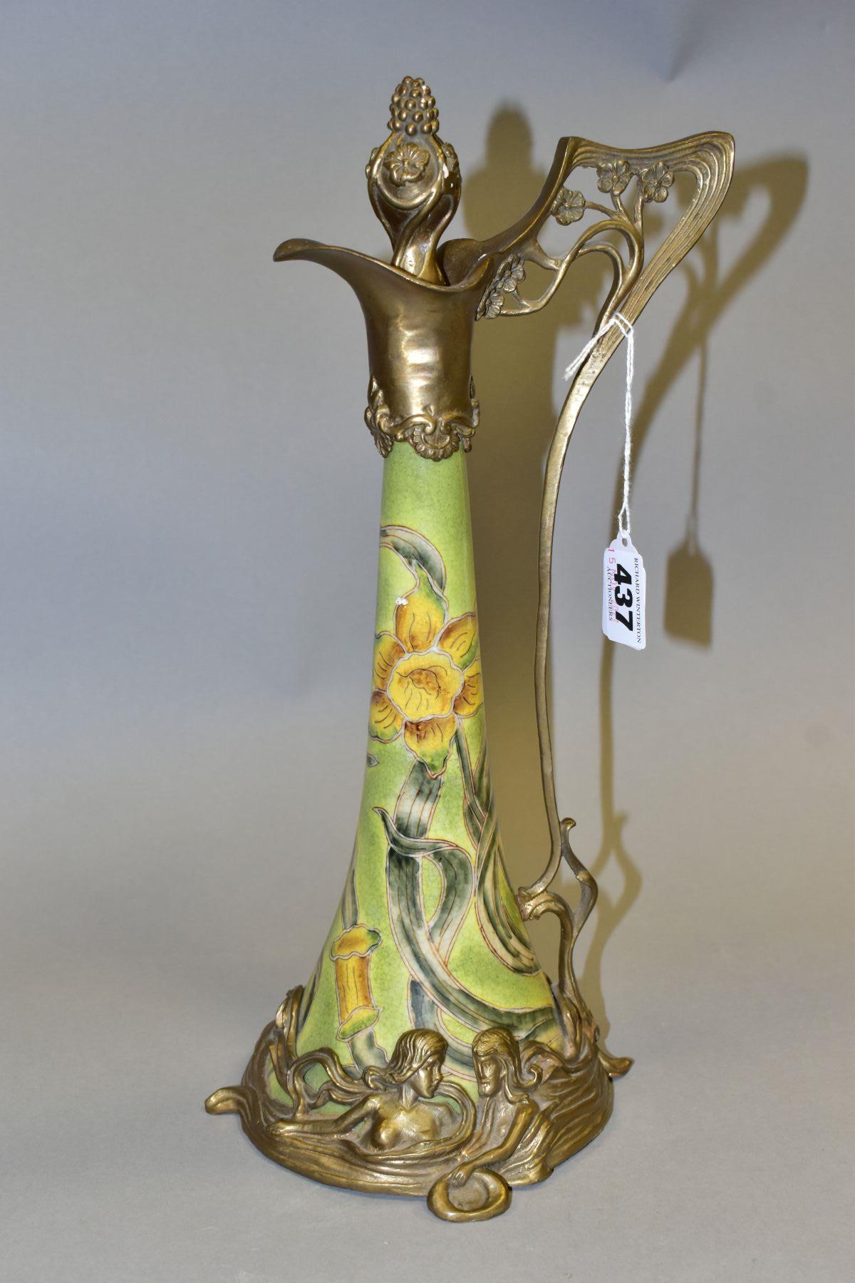 A REPRODUCTION ART NOUVEAU STYLE BRASS MOUNTED CERAMIC EWER, with foliate stopper, the wavy lip with