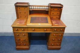 A VICTORIAN MAHOGANY DICKENS DESK, the top with a hinged slopped writing surface enclosing a