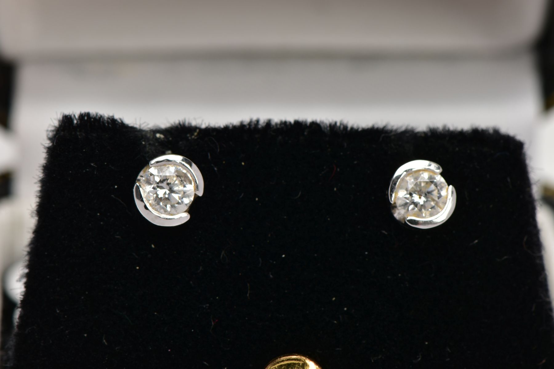 A PAIR OF 18CT GOLD DIAMOND STUD EARRINGS, each set with a single round brilliant cut diamond, total