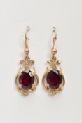 A PAIR OF 9CT GOLD GARNET DROP EARRINGS, each designed with a central oval cut garnet, within an