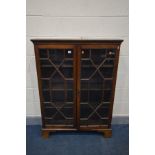 A GEORGIAN MAHOGANY ASTRAGAL GLAZED TWO DOOR BOOKCASE, with three adjustable shelves, on bracket