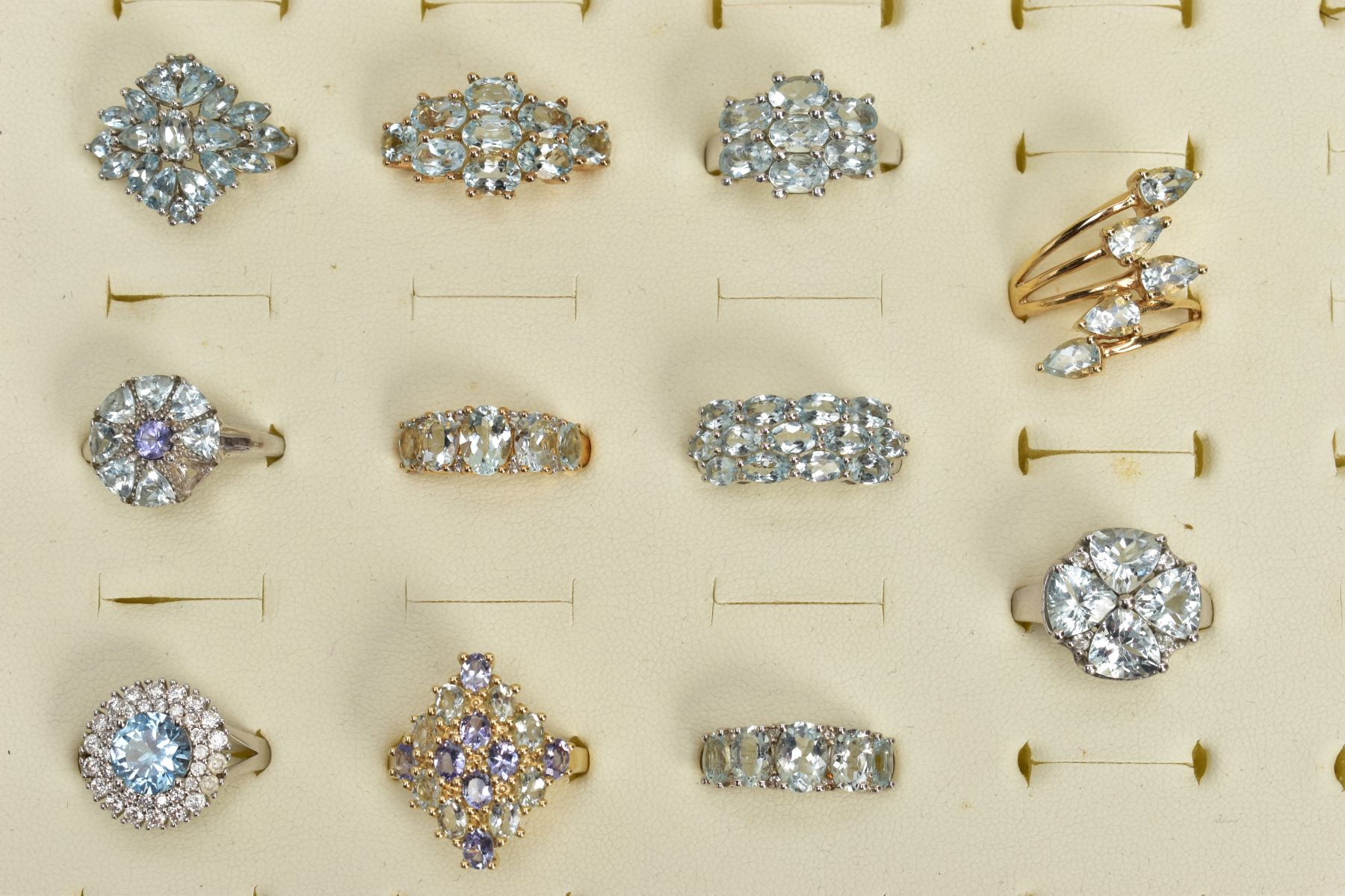 ELEVEN GEM SET RINGS, to include a five stone ring designed as a graduated row of aquamarines, one