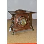 AN ARTS AND CRAFTS COPPER HAND HAMMERED CASED MANTEL CLOCK, the domed rectangular overhanging top