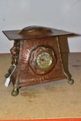 AN ARTS AND CRAFTS COPPER HAND HAMMERED CASED MANTEL CLOCK, the domed rectangular overhanging top