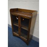 A STAINED OAK GLAZED TWO DOOR BOOKCASE, width 60cm x depth 28cm x height 89cm