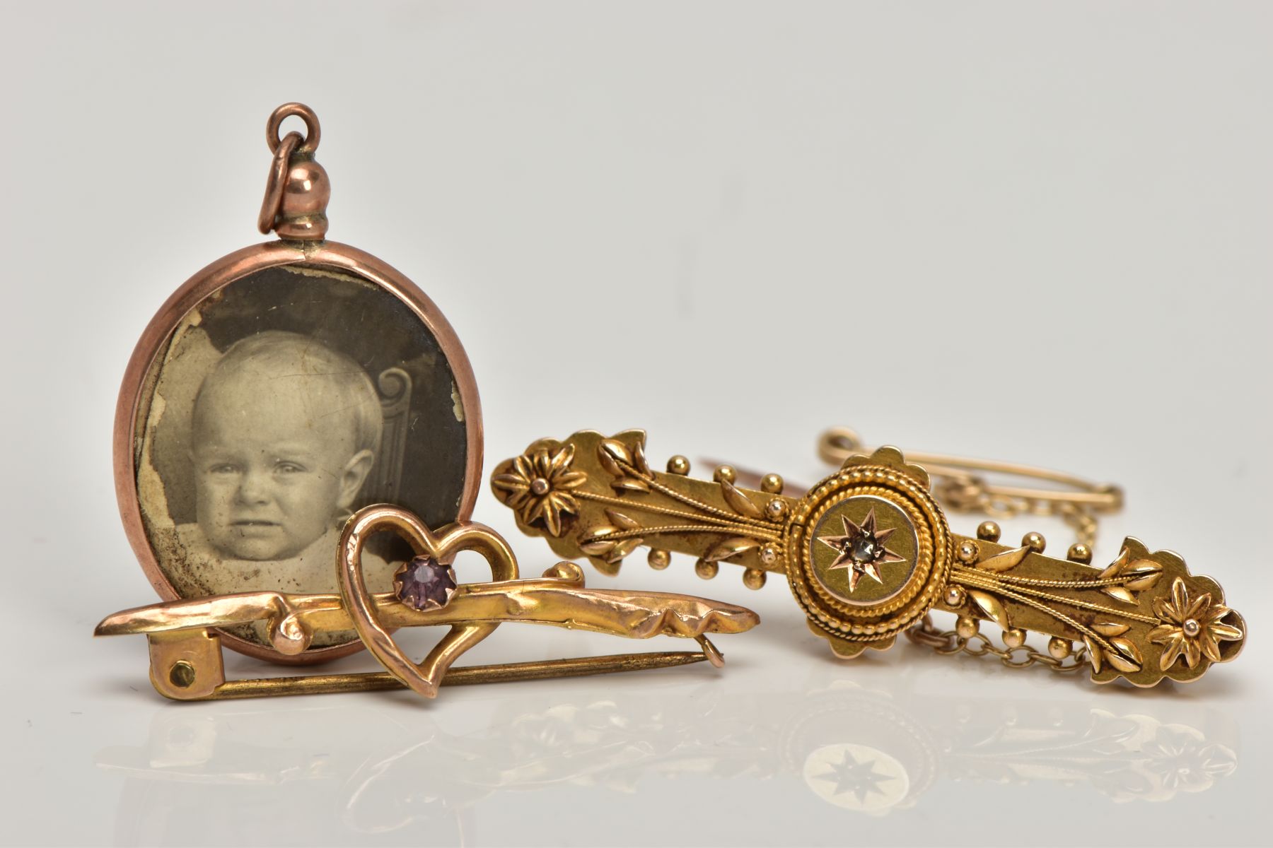 A VICTORIAN BROOCH, HEART BROOCH AND LOCKET, the Victorian brooch designed with a star set, rose cut