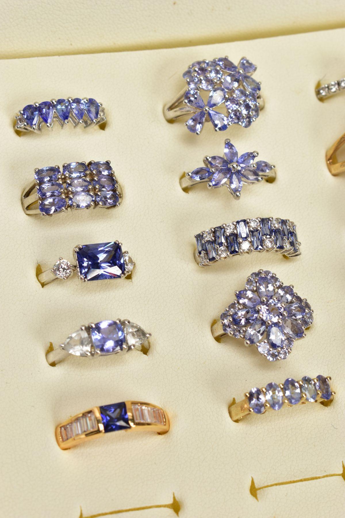 SEVENTEEN GEM SET RINGS AND A RING BOX, most set with vary cut tanzanite's, to include clusters, - Image 3 of 4
