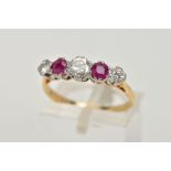A YELLOW METAL RUBY AND DIAMOND FIVE STONE RING, designed with three round brilliant cut diamonds,