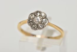 A YELLOW METAL DIAMOND CLUSTER RING, the cluster of a flower shape, set with eight old cut diamonds,