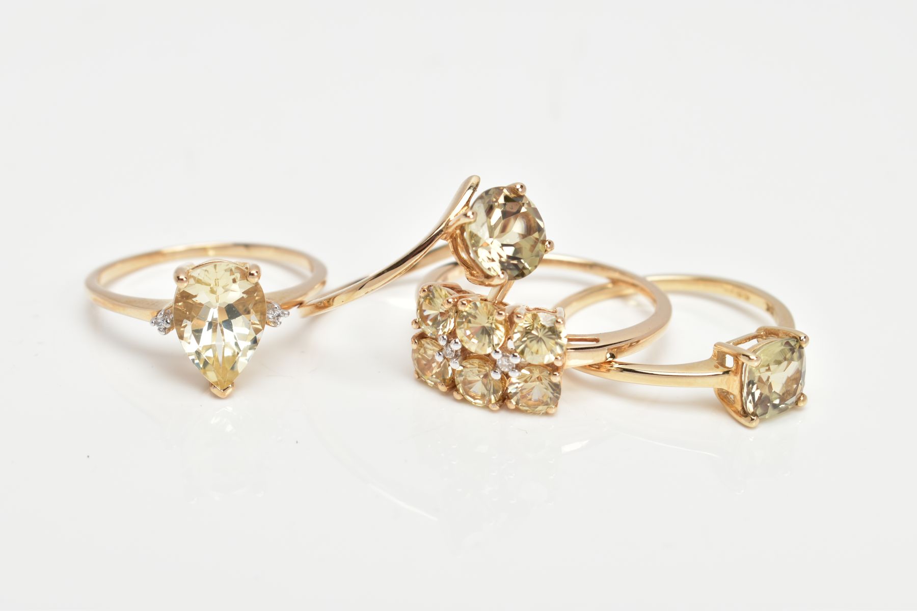 FOUR 9CT GOLD GEM SET DRESS RINGS, each set with pale yellowish green stones (untested) of various - Image 2 of 3