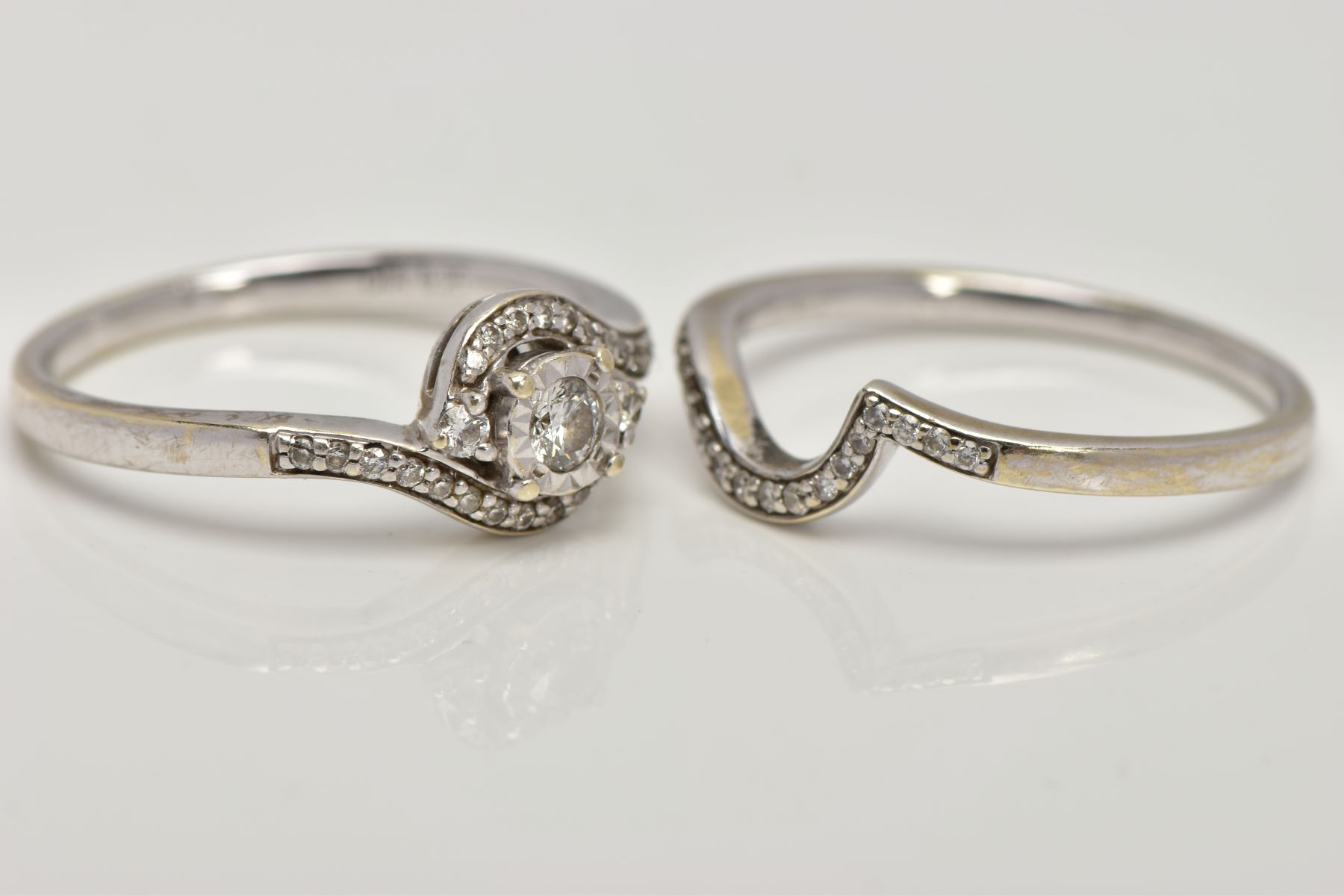 A 9CT WHITE GOLD DIAMOND RING SET, to include a single stone crossover ring set with a central - Image 2 of 4