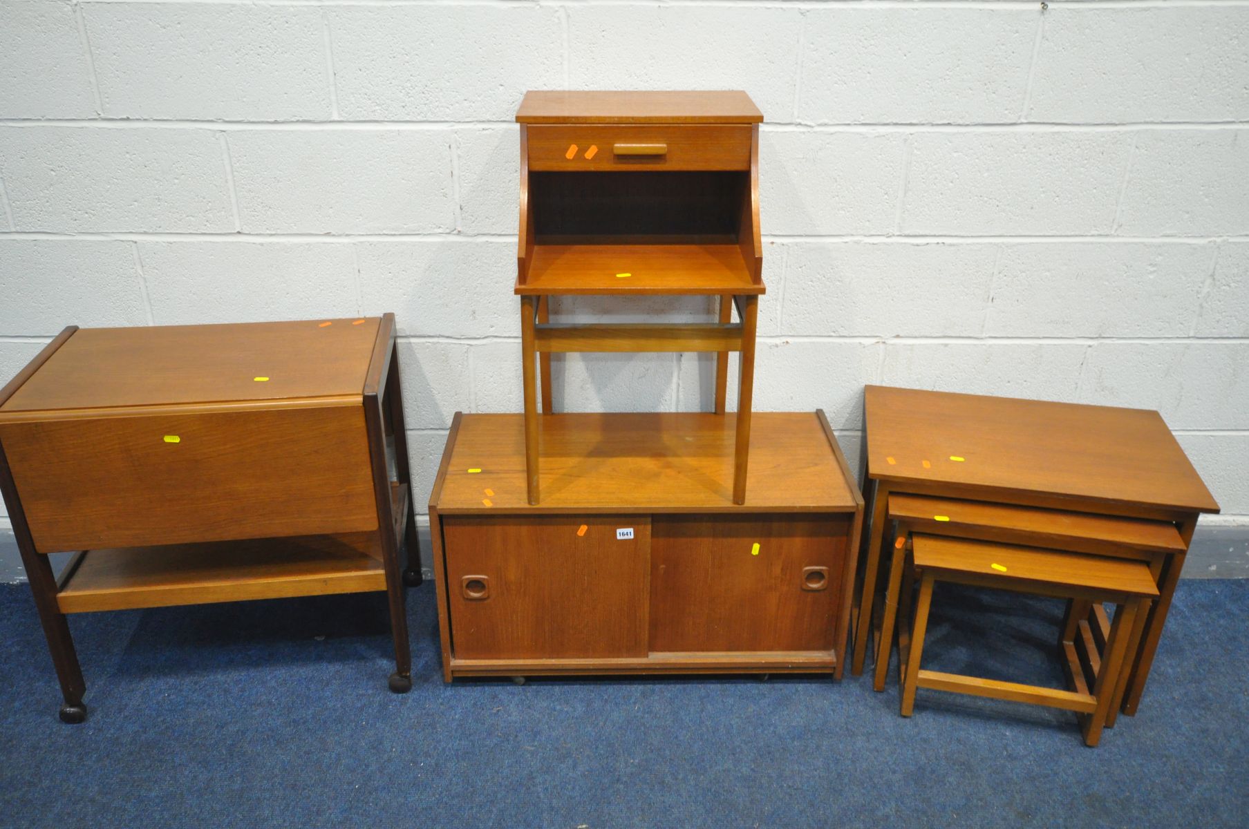 FOUR VARIOUS MID CENTURY TEAK OCCASIONAL FURNITURE, to include a sliding two door cabinet, telephone