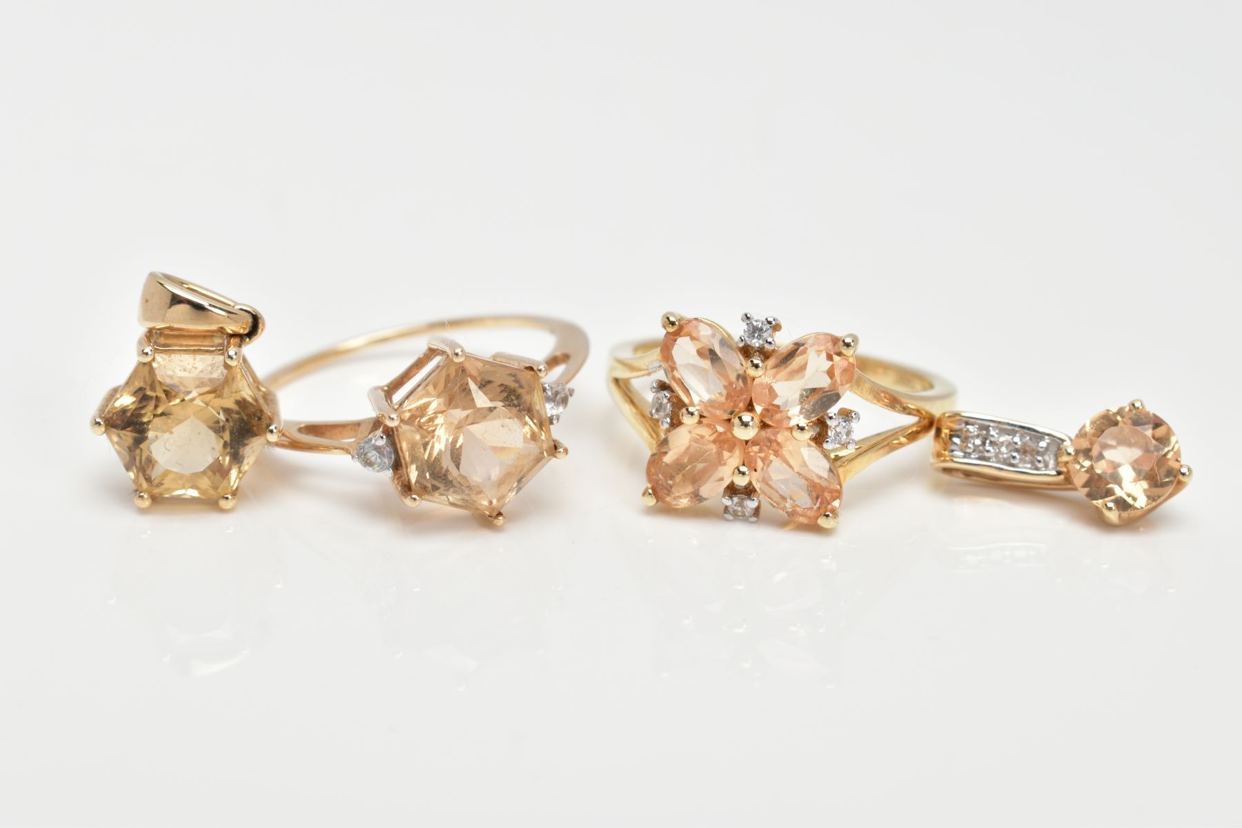 TWO 9CT GOLD CITRINE RINGS AND TWO PENDANTS, the first designed with a six claw set hexagonal cut