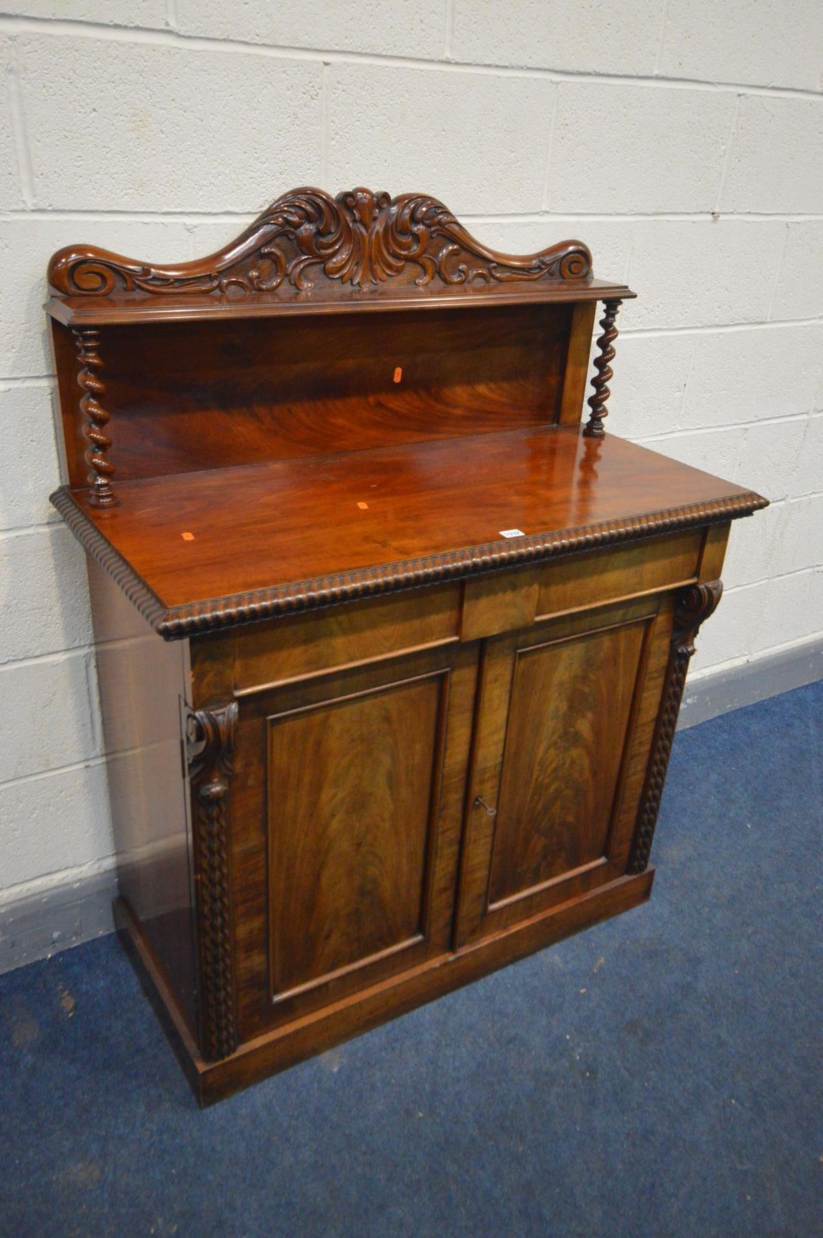 A VICTORIAN FLAME MAHOGANY CHIFFONIER, with a foliate carved raised back supported by barley twist