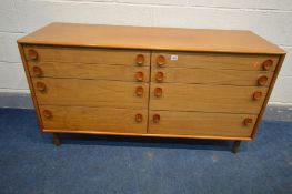 A MID CENTURY MEREDEW TEAK SIDEBOARD/CHEST OF EIGHT GRADUATED DRAWERS, with oval handles, width