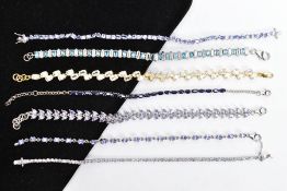 SEVEN GEM SET LINE BRACELETS, such as a white metal line bracelet set with twenty-three claw set,