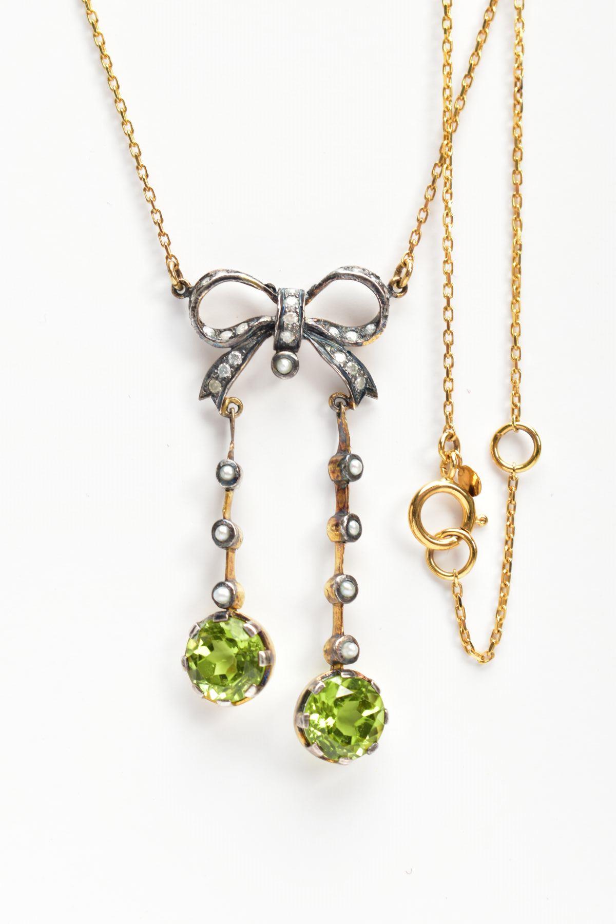 A YELLOW METAL PERIDOT AND SEED PEARL PENDANT NECKLACE, the pendant of a bow shape set with single - Image 2 of 2