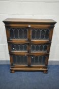 A SIMPOLES OAK THREE SECTION BOOKCASE, each section with double lead glazed doors, on a base with