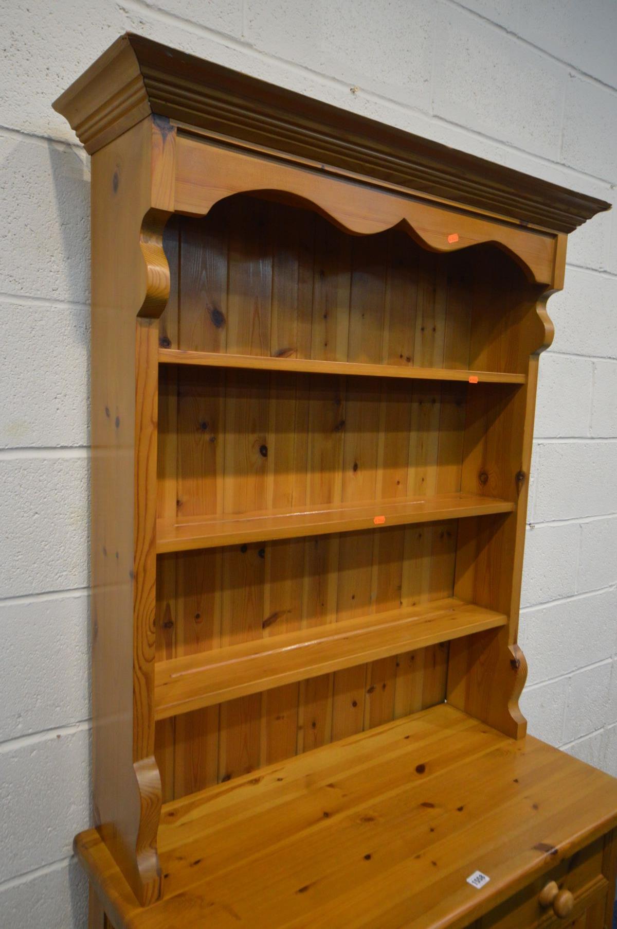 A SLIM PINE DRESSER, the top with triple plate rack, over a base with two drawer and double cupboard - Image 2 of 3