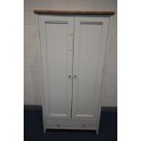 A PARTIAL OAK AND WHITE FINISH TWO DOOR WARDROBE, with a single drawer, width 104cm x depth 65cm x