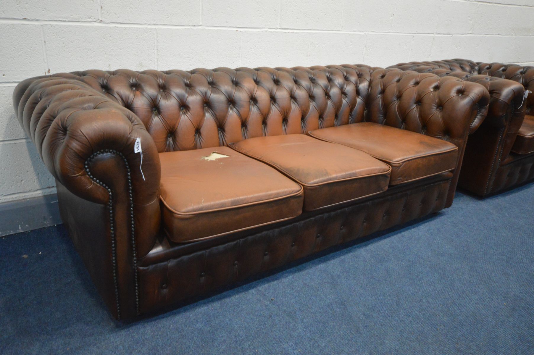 A BROWN LEATHER CHESTERFIELD SUITE, comprising a three seater sofa, length 195cm, and a tub chair, - Image 2 of 4