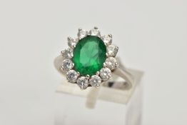 A 9CT WHITE GOLD CLUSTER RING, designed with a central green stone assessed as paste, within a