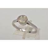 A WHITE METAL DIAMOND RING, designed with a faceted slice of diamond, within a cone shaped mount, (