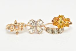 FOUR 9CT GOLD GEM SET DRESS RINGS, to include an orange sapphire seven stone ring, a marquise