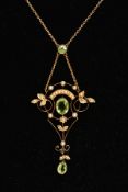 AN EDWARDIAN PENDANT NECKLACE, the openwork scroll detailed pendant, set with a central oval cut