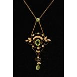 AN EDWARDIAN PENDANT NECKLACE, the openwork scroll detailed pendant, set with a central oval cut