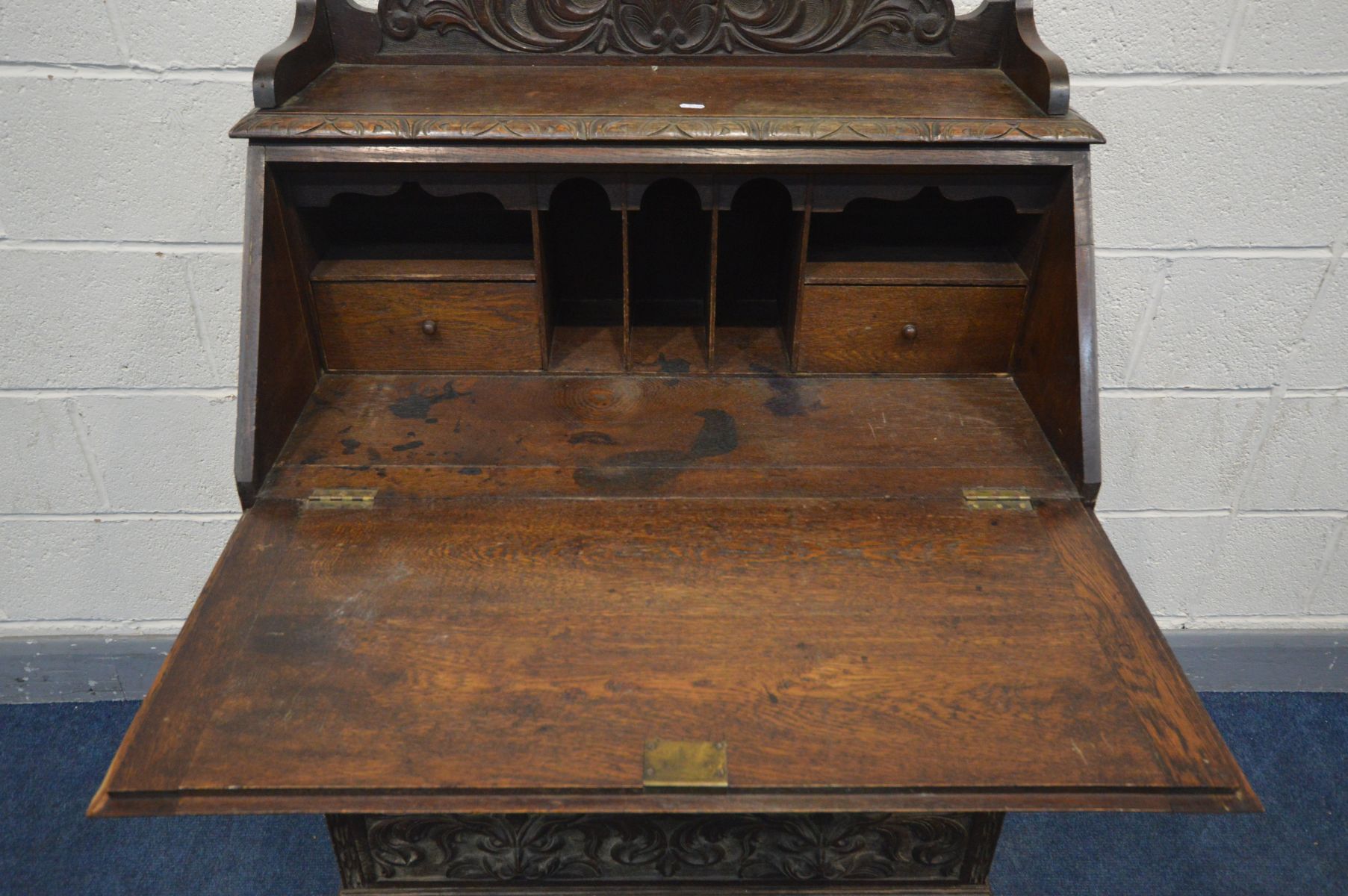 AN EARLY 20TH CENTURY CARVED OAK BUREAU, gallery top, the fall front with a fitted interior, above - Image 3 of 4