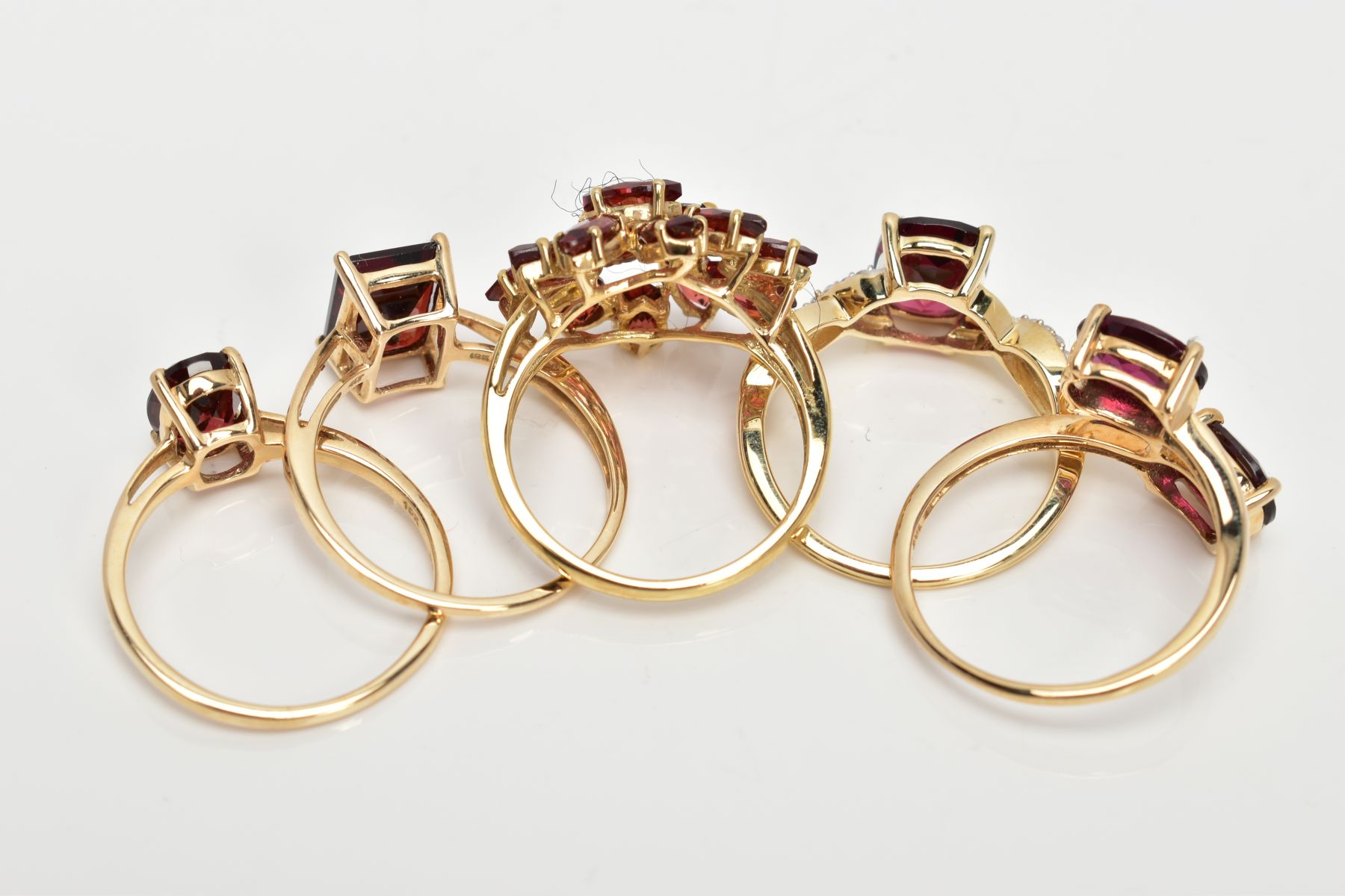 FIVE 9CT GOLD GEM SET DRESS RINGS, various designs, set with vary cut garnets, one also set with - Image 3 of 3