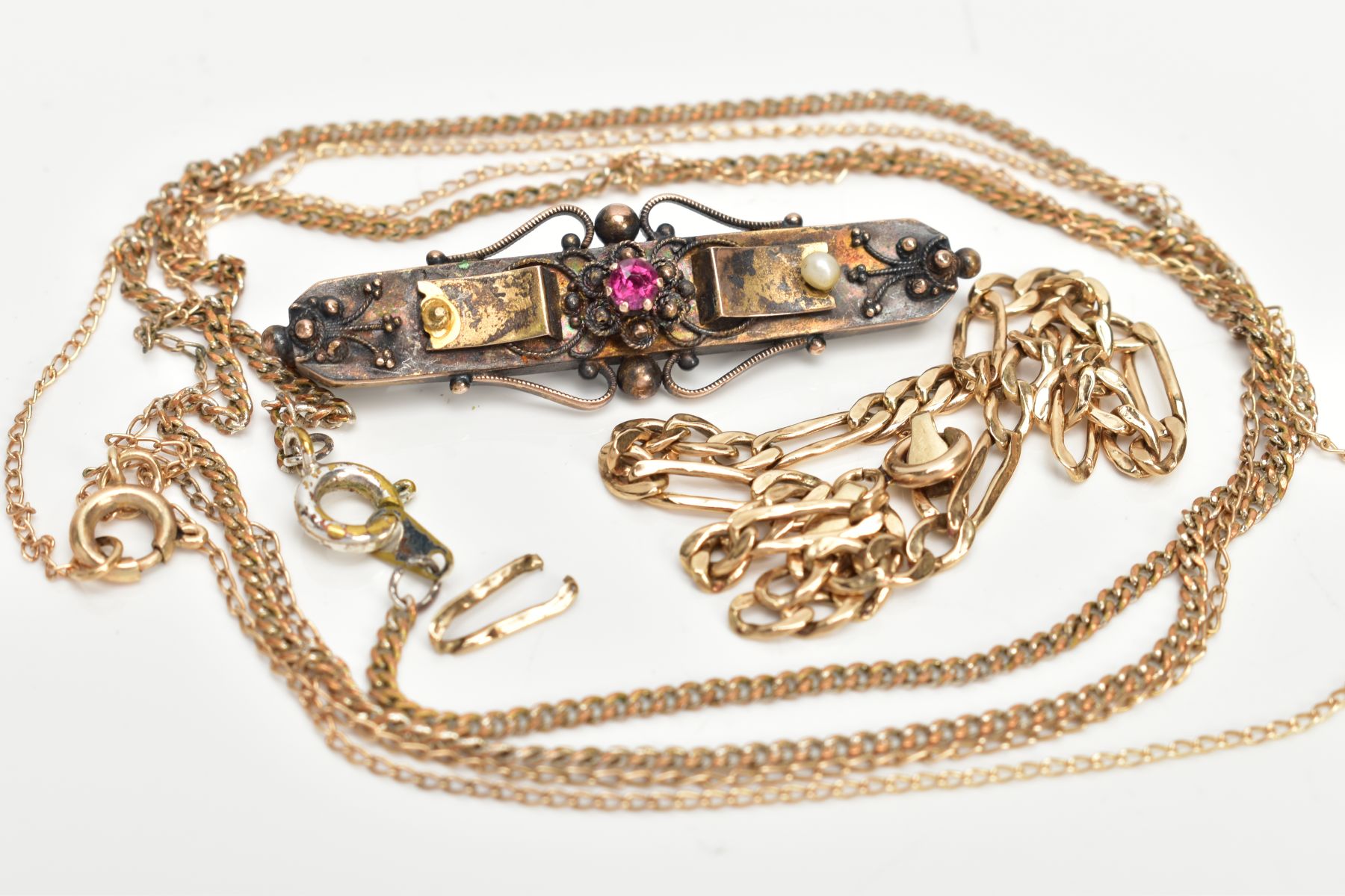 AN EARLY 20TH CENTURY GOLD RUBY AND SEED PEARL BROOCH WITH THREE YELLOW METAL CHAINS, floral