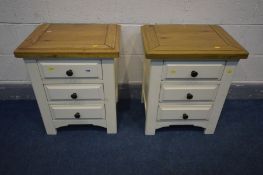 A PAIR OF OAK AND PARTIALLY PAINTED CREAM BEDSIDE CABINETS with three drawers, width 54cm x depth