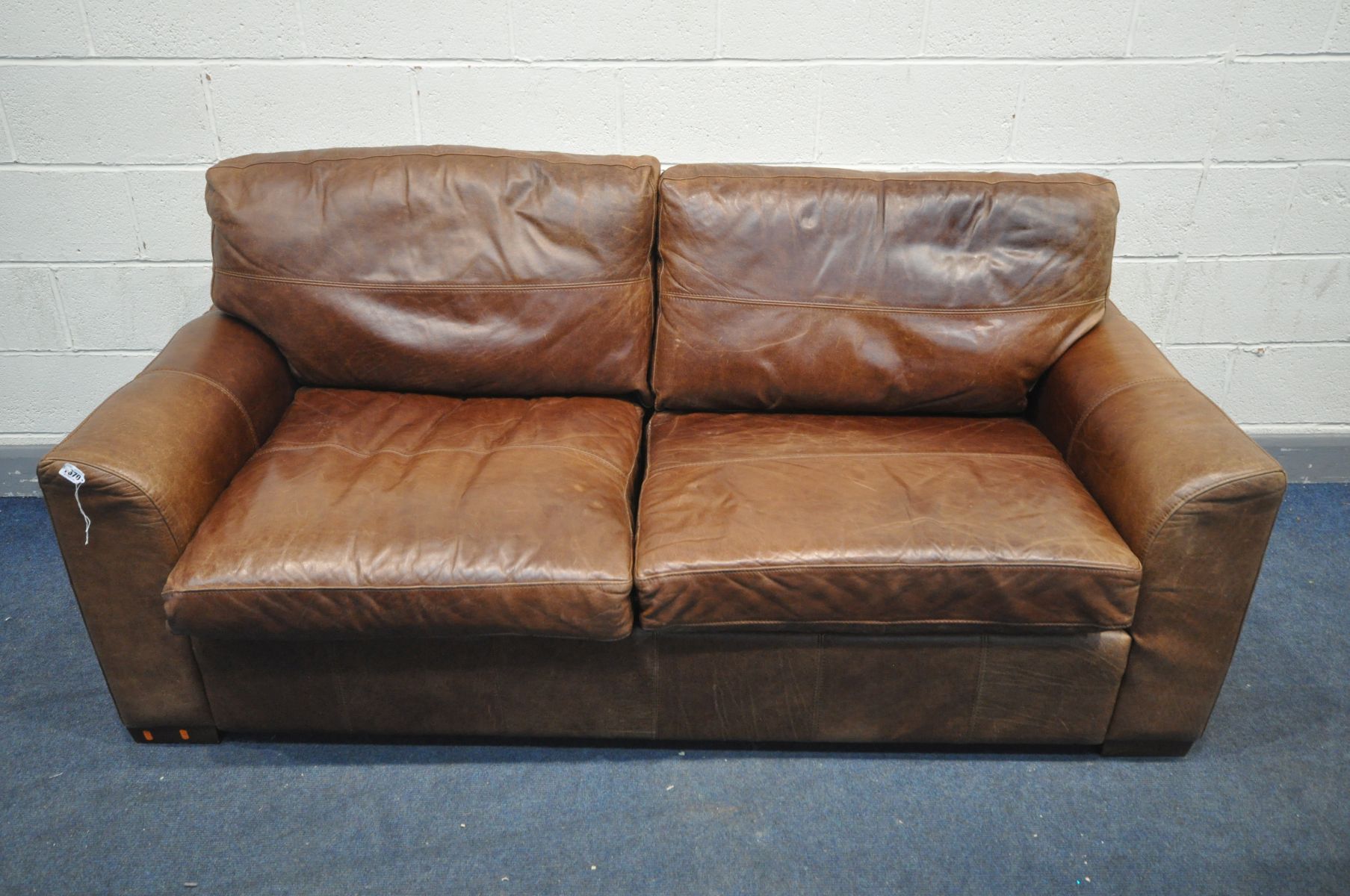 A BROWN LEATHER TWO SEATER SOFA, length 195cm
