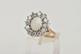 A 9CT GOLD OPAL AND CUBIC ZIRCONIA CLUSTER RING, of an oval design, set with a central oval opal