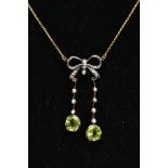 A YELLOW METAL PERIDOT AND SEED PEARL PENDANT NECKLACE, the pendant of a bow shape set with single