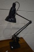 A HEBERT TERRY BLACK FINISH ANGLE POISE DESK LAMP, on a stepped base