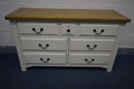 AN OAK AND PARTIALLY PAINTED CREAM SIDEBOARD, with a central small drawer flanked by two short