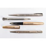 A PARKER FOUNTAIN PEN AND THREE PROPELLING PENCILS, the gold tone Parker pen within an engine turned