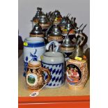 A GROUP OF STEINS AND TANKARDS, to include nine lidded steins, eight ceramic and one cut glass, with